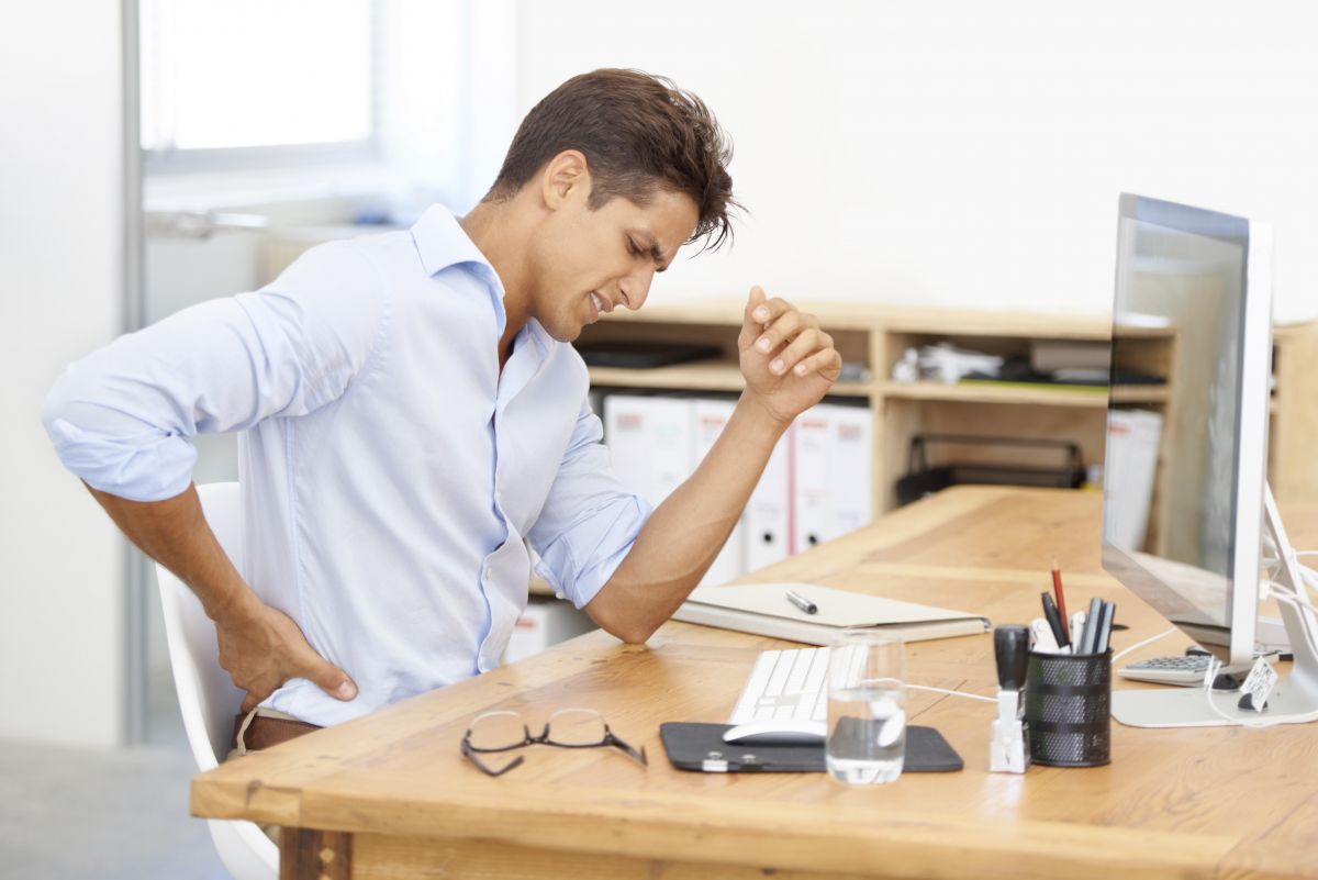 Ergonomics Desk Male Male at desk with back pain
